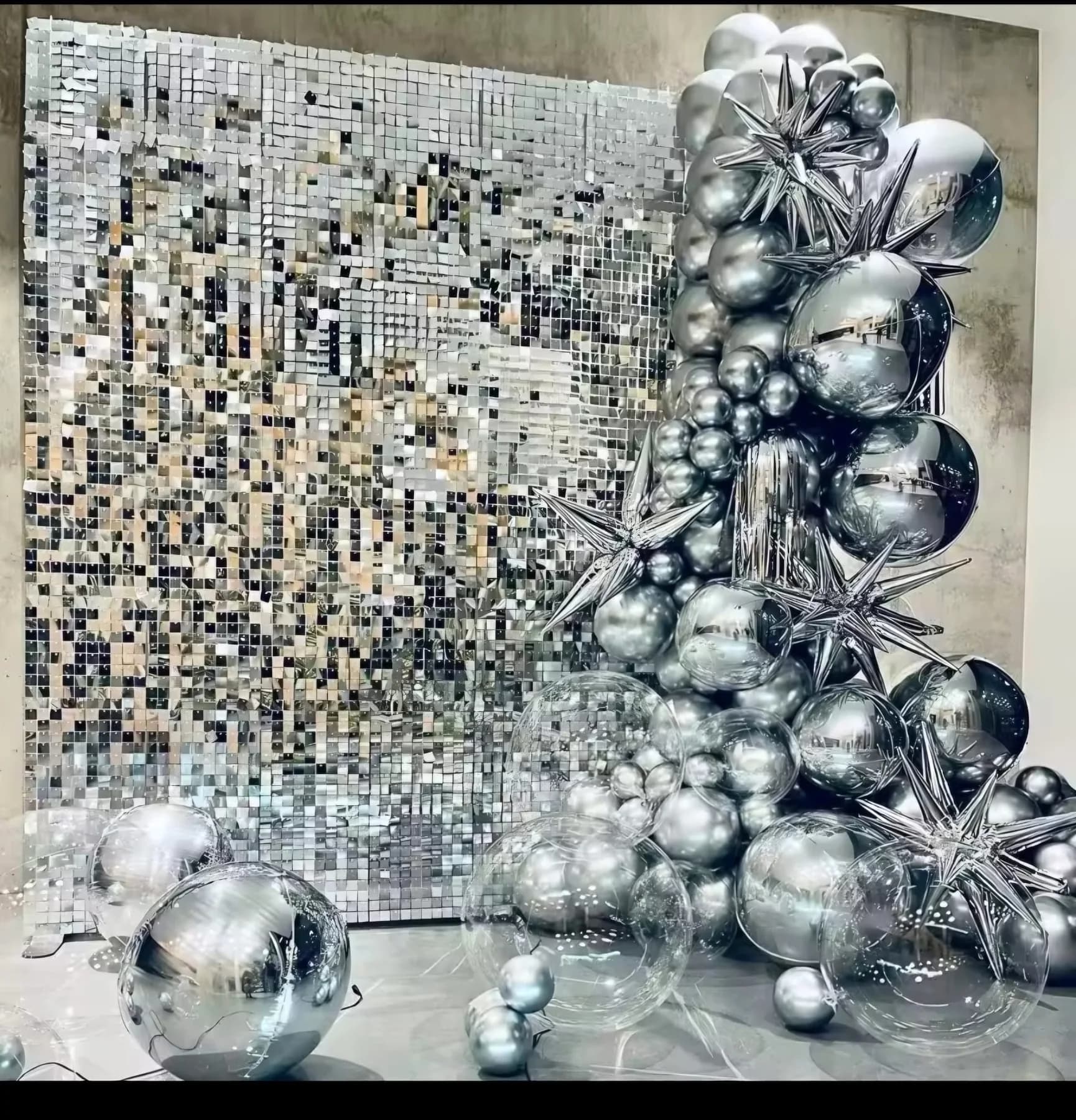Silver shimmer wall with metallic balloon decor and star accents