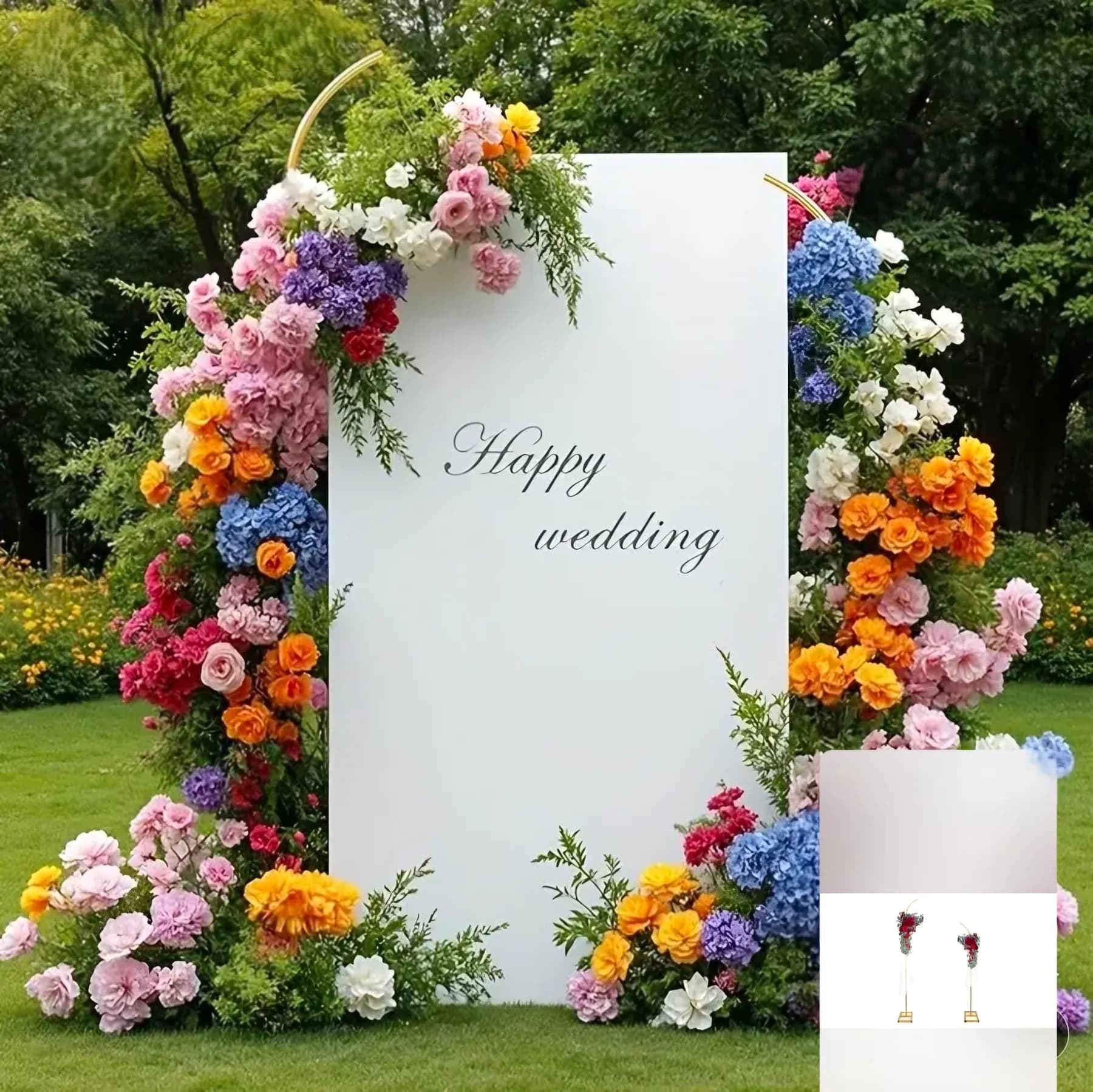 Large floral arch with a wedding sign surrounded by greenery