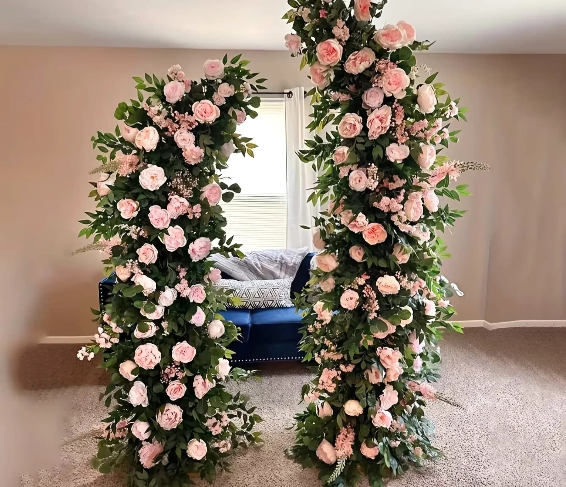 Round mirror framed with pink rose floral decor